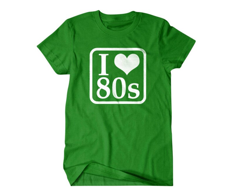 May include: Green t-shirt with a white square graphic that says "I love 80s" with a heart in place of the "o".