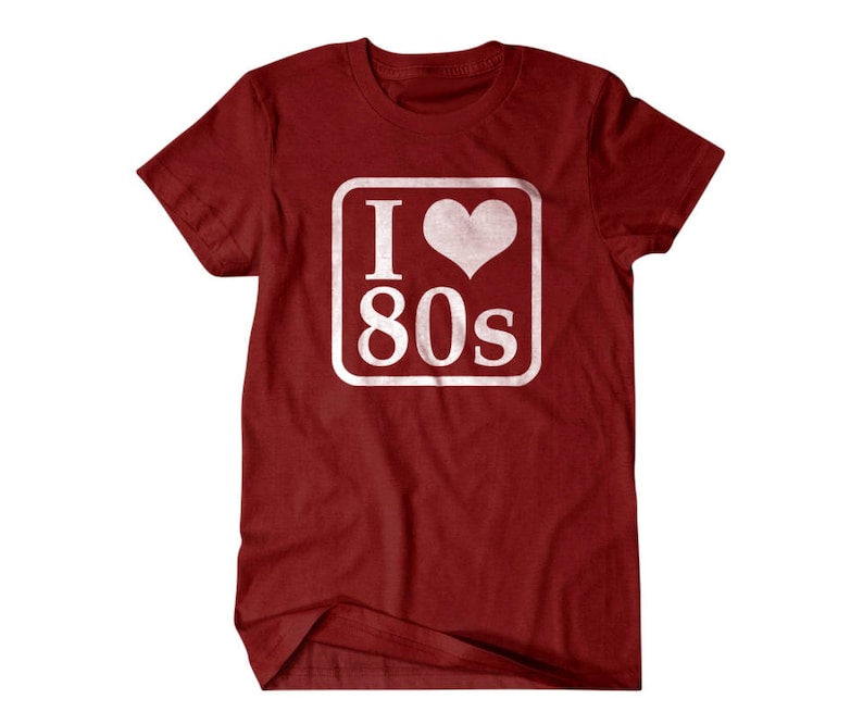 May include: Red t-shirt with a white square graphic that says "I love 80s" with a heart in place of the "O".