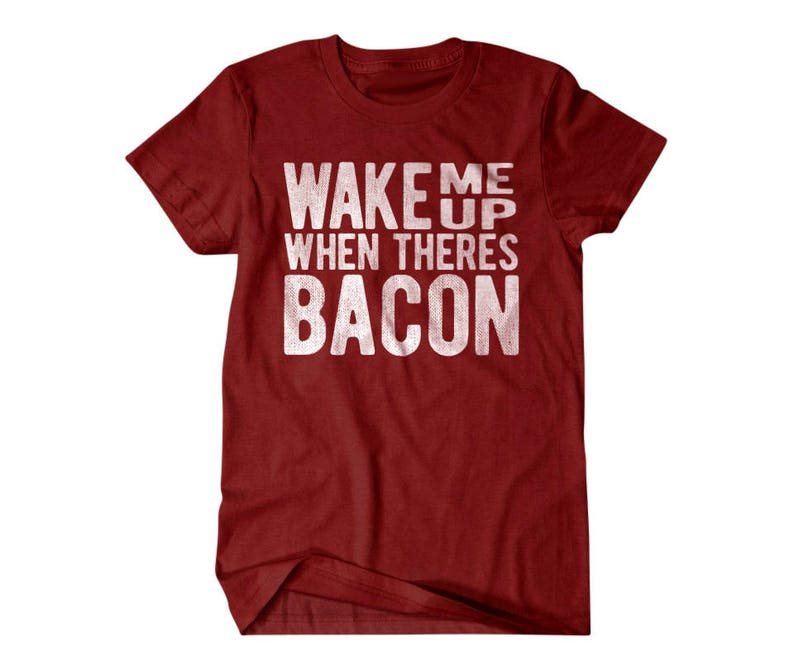 May include: Red t-shirt with white text that reads "Wake me up when there's bacon".