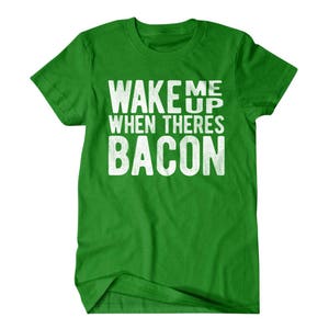 May include: Green t-shirt with white text that reads "Wake me up when there's bacon".
