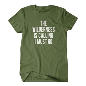 May include: A green t-shirt with the text "The Wilderness is Calling I Must Go" in white.