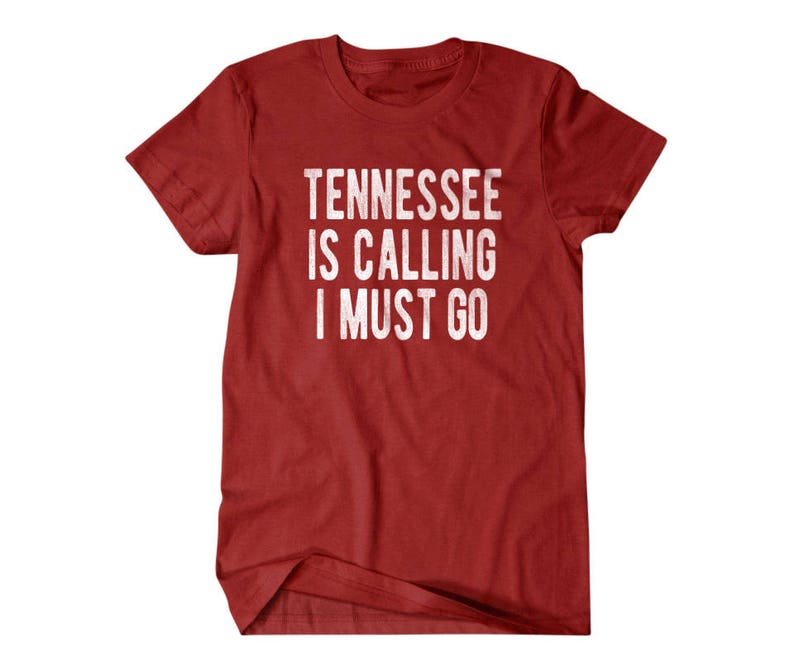 May include: Red t-shirt with white text that reads "Tennessee is calling I must go".