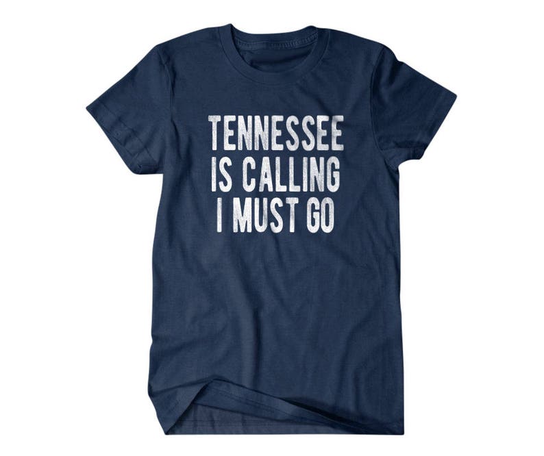 May include: A navy blue t-shirt with the text "Tennessee is calling I must go" in white.