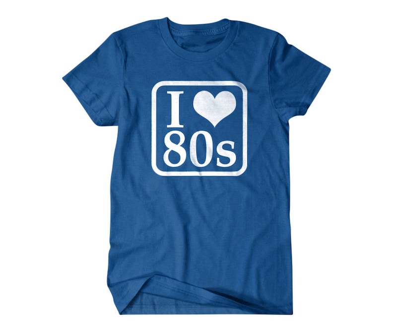 May include: A royal blue t-shirt with a white square graphic that says "I love 80s" with a white heart in the middle of the "I".