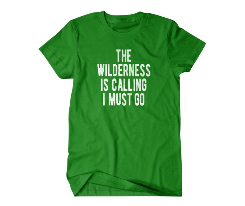 May include: Green t-shirt with white text that reads "The Wilderness is Calling I Must Go".