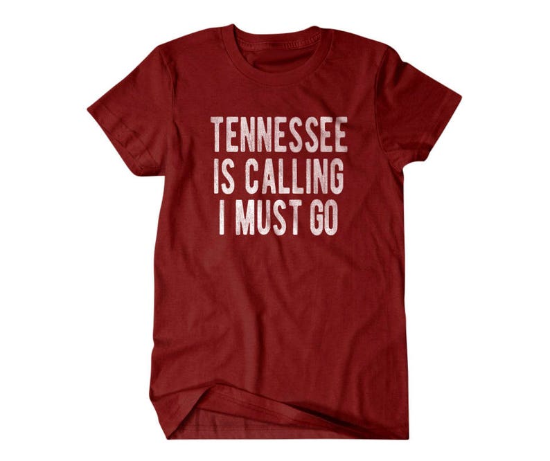 May include: Red t-shirt with white text that reads "Tennessee is calling I must go".