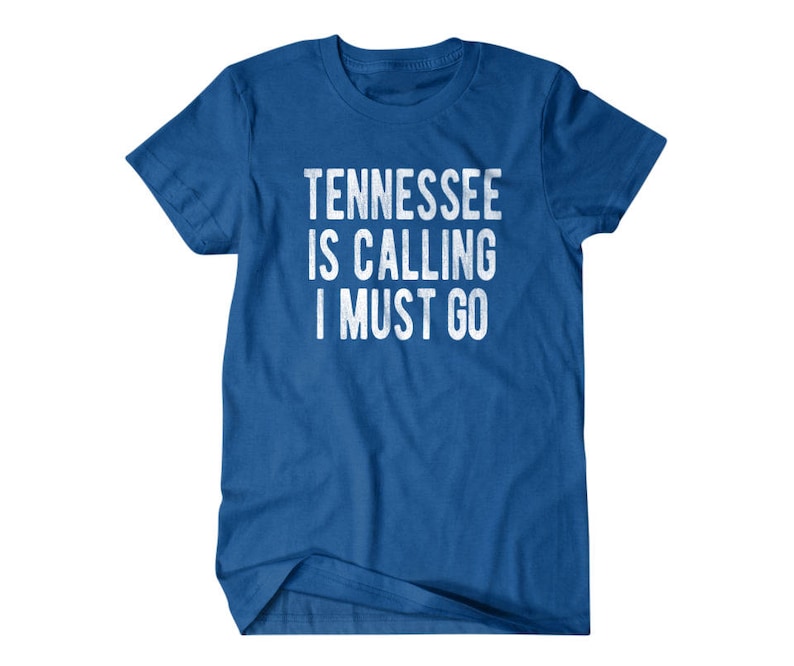 May include: A royal blue t-shirt with the text "Tennessee is calling I must go" in white.
