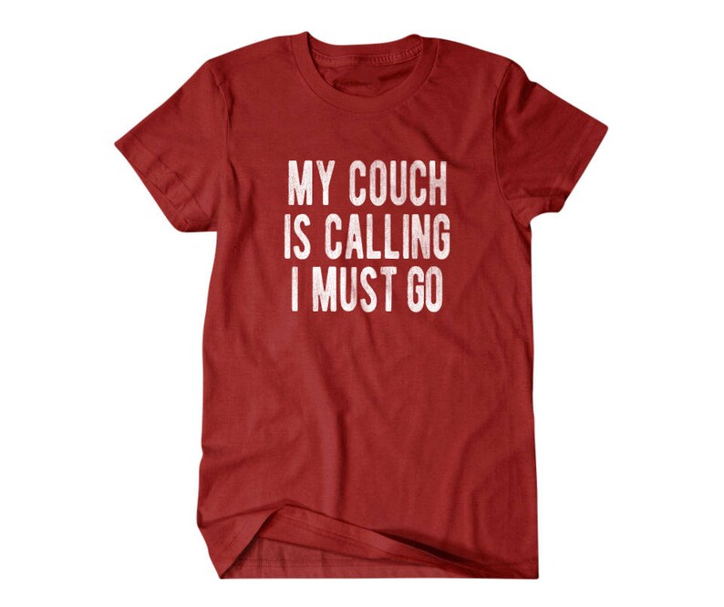 May include: Red t-shirt with the text "My couch is calling I must go" in white.