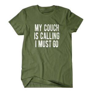 May include: A green t-shirt with the text "My couch is calling I must go" printed in white.