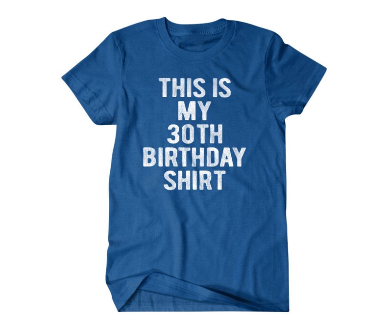 Puede incluir: Una camiseta azul real con el texto "This is my 30th Birthday Shirt" en blanco.