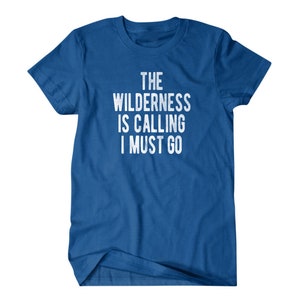 May include: A royal blue t-shirt with white text that reads "The Wilderness is Calling I Must Go".