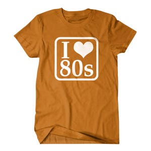 May include: A brown t-shirt with a white square graphic that says "I love 80s" with a heart in place of the "o".