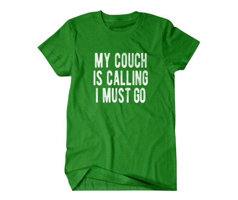 May include: Green t-shirt with white text that reads "My couch is calling I must go."