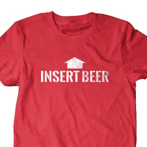 May include: Red t-shirt with a white graphic of an arrow pointing up and the text "INSERT BEER".