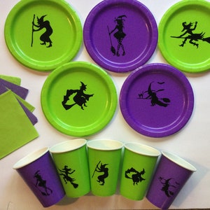 May include: A set of Halloween party supplies featuring green and purple paper plates and cups with black witch silhouettes. The set includes napkins in matching colors.