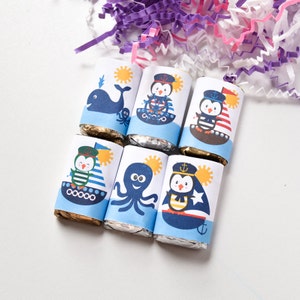 May include: Six small chocolate bars wrapped in foil with colorful nautical themed paper wrappers. The wrappers feature penguins, an octopus, a whale, and a sailboat.