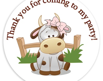 May include: A white circle sticker with a brown border. The sticker features a cartoon cow with brown spots, a pink bow, and a brown fence. The text "Thank you for coming to my party!" is written in brown around the edge of the sticker.