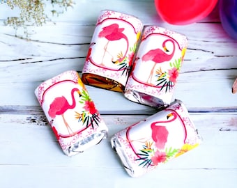 May include: Four small wrapped chocolate bars with pink flamingo designs and tropical flowers. The wrappers are white with a pink, green, and yellow floral pattern.