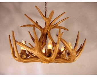 May include: A rustic chandelier made from antlers with six light bulbs. The chandelier is made of natural brown antlers and has a rustic, natural look.