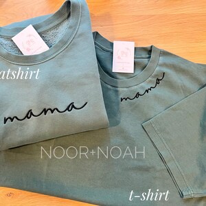 May include: A set of two green shirts with the word "mama" embroidered on them. The larger shirt is a sweatshirt and the smaller shirt is a t-shirt. The shirts are labeled "sweatshirt" and "t-shirt" in the image.