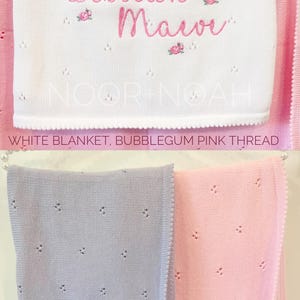 May include: White baby blanket with the name "Lillian Maeve" embroidered in bubblegum pink. The blanket has a delicate, openwork design and is displayed with purple and baby pink blankets.