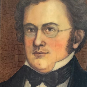 May include: A portrait painting of a man wearing a black suit with a white shirt and a black bow tie. He has curly brown hair and is wearing glasses. The background is a brown textured surface.