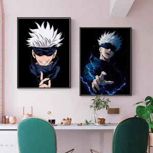 May include: Two framed anime art prints. Each features a character with white hair, a black blindfold, and a dark blue outfit against a black background. One print shows the character smiling, the other with blue lightning.