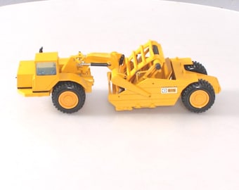 NZG 260 Caterpillar 615C Wheel Tractor with Elevating Scraper   1:50 Scale  Die-cast  Made in Germany