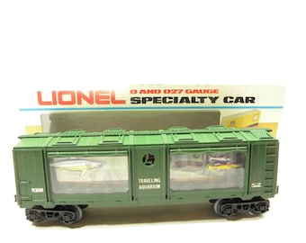 May include: A green Lionel O and O27 gauge model train car with a clear plastic window that says "Traveling Aquarium". The car has a number "9308" on the side.