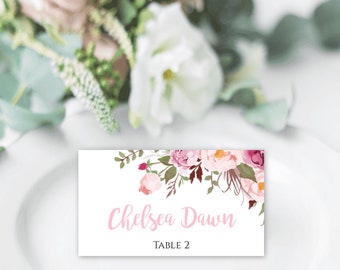 May include: Pink floral wedding place card with the name "Chelsea Dawn" and "Table 2" printed on it.