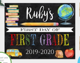 May include: Editable first day of school sign template with a chalkboard background. The sign features a stack of books, a pencil, a globe, a school bus, a lunch bag, and an apple. The text on the sign reads "Ruby's First Day of First Grade 2019-2020".
