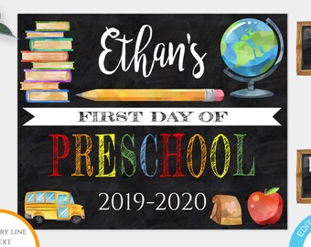 May include: A chalkboard-style sign template for the first day of preschool. The design includes a stack of books, a globe, a pencil, a school bus, an apple, and the text "Ethan's" and "Preschool 2019-2020". The sign is 10" x 8".