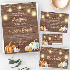 May include: A rustic wooden background with a string of lights and pumpkins. The text "We're Adding Another Pumpkin To The Patch" is at the top of the invitation. The invitation is for a baby shower for Kassandra Daniels. The date and time of the shower are November 12, 2022 at 2 PM. The address is 1234 Valley View Ave, Corona, CA 92881. The RSVP information is to Kim by Nov. 1st (951) 555-1234. The text "Registered at Target + Amazon" is at the bottom of the invitation.