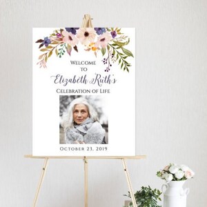 May include: A 16 x 20 inch sign with a floral design and a photo of a woman. The sign says "Welcome to Elizabeth Ruth's Celebration of Life" and "October 23, 2019". The text on the sign says you can edit the font style, size, and color, but not the color of the flowers. You can edit 100% of the layout and text using a free application. The sign is on a wooden easel.