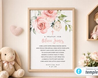 May include: A framed wall art print featuring a watercolor illustration of pink roses and green leaves at the top, a small pink cross, and the text A PRAYER FOR Olivia James followed by a religious poem and the text BAPTISM DAY 9.27.20.