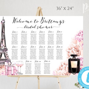 May include: A printable bridal shower seating chart with a Parisian theme. The chart features a black and white illustration of the Eiffel Tower, pink and white flowers, and a bottle of perfume. The chart is 91.44 cm by 60.96 cm and includes a table layout with names for each guest.