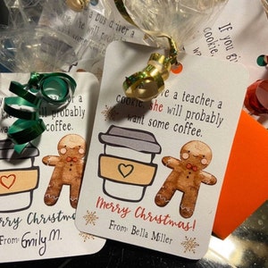 May include: Two Christmas gift tags with a gingerbread man and a cup of coffee. The tags have the text "If you give a teacher a cookie, she will probably want some coffee." and "Merry Christmas! From: Bella Miller".