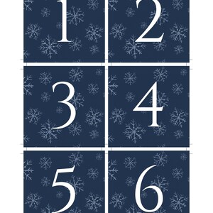 May include: Six blue square cards with white snowflake patterns. Each card has a white number, 1 through 6, in the center.