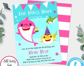 May include: A pink and blue birthday invitation with a cartoon baby shark holding a cupcake. The invitation says "Our Baby Shark is turning one" and includes the text "Join Us As We Celebrate The Birthday Girl Briar Rose September 22, 2021 at 2pm 40620 Calle Contento, Temecula, CA. RSVP To Brittany by Sept. 10th (951) 555-1234 5" X 7" - PRINT AS MANY AS YOU WANT! EDIT + PRINT TODAY"