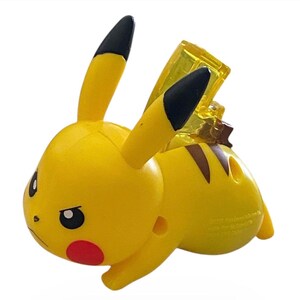 May include: A yellow Pikachu figurine with black-tipped ears, red cheeks, and brown stripes on its back. The figurine has a determined expression and a clear, yellow lightning bolt accessory.
