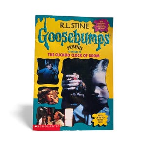 May include: A vintage Goosebumps book titled "The Cuckoo Clock of Doom" by R.L. Stine. The cover features a yellow background with the series title in teal and a teal border. Images from the TV show are also featured.
