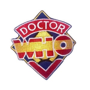 May include: A red, white, and gold embroidered patch with the words "Doctor Who" in a diamond shape.
