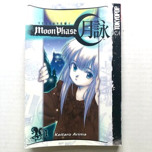 May include: Volume 1 of the manga series "Tsukuyomi Moon Phase" by Keitaro Arima. The cover features a young girl with long, white hair and a dark dress, standing in front of a crescent moon with the Japanese word for "moon" written in large, black characters.