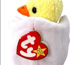 Peut inclure: Un jouet en peluche en forme d'œuf blanc contenant un poussin jaune en peluche. Le jouet a une étiquette Ty rouge avec les mots "Beanie Original Baby" dessus.