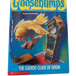 May include: A paperback book titled "Goosebumps: The Cuckoo Clock of Doom" by R.L. Stine. The cover features a yellow bird with blue eyes perched on a wooden plank, and a grandfather clock. The background is blue.