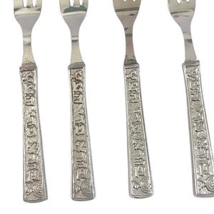 Puede incluir: Juego de cuatro tenedores de plata con mangos adornados con texto hebreo. Los tenedores están diseñados para servir postres o aperitivos.