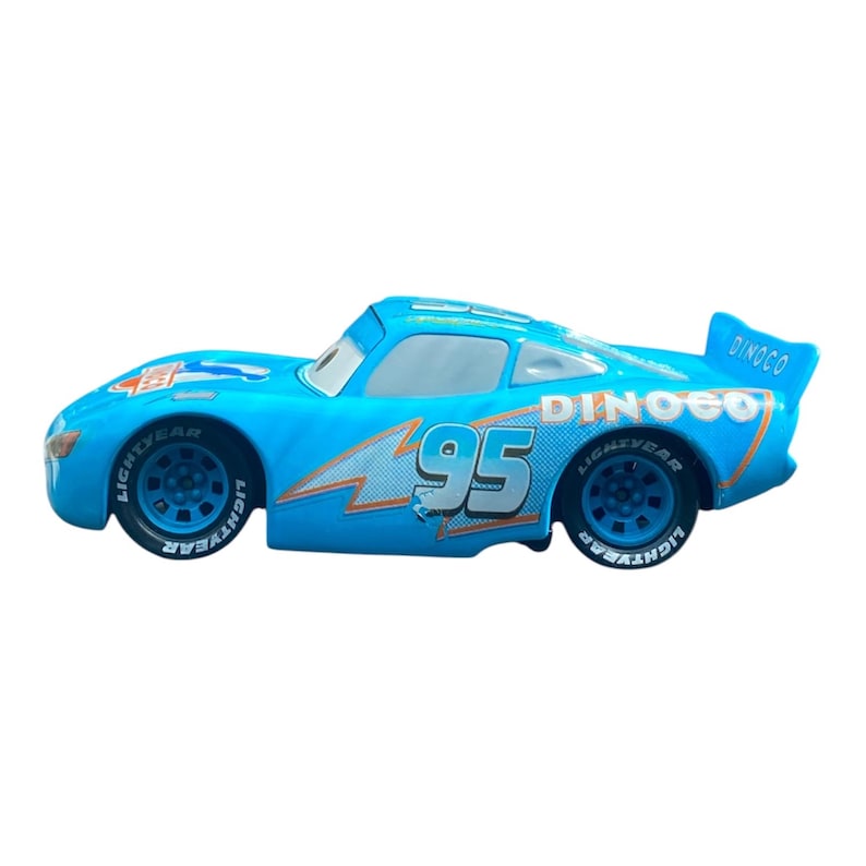 May include: A light blue toy race car with the number 95 on the side. The car has the word "LIGHTYEAR" on the tires and "DINCO" on the spoiler. The car has orange and white lightning bolt graphics.
