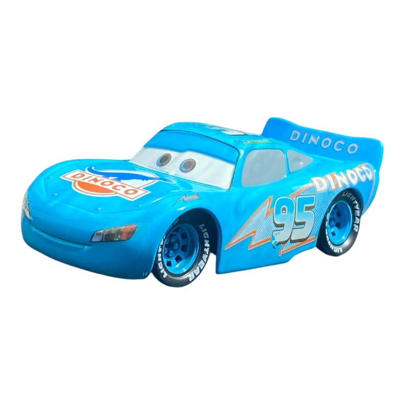 May include: A light blue toy car with the number 95 on the side. The car has the word "Dinoco" in orange and white on the hood and spoiler. The car has large eyes on the windshield and the word "Lightyear" on the tires.