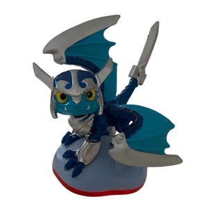 May include: A blue and silver dragon figurine with large wings and a helmet. The figure has yellow eyes and is perched on a light blue cloud-shaped base with a red bottom. The dragon has two silver swords.