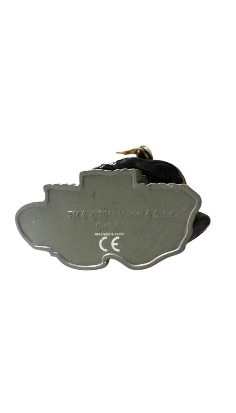 May include: A gray plastic figurine of a character from the Marvel universe. The bottom of the figurine has the text "TM & &copy; 2011 Marvel & Subs. CHINA  CE".